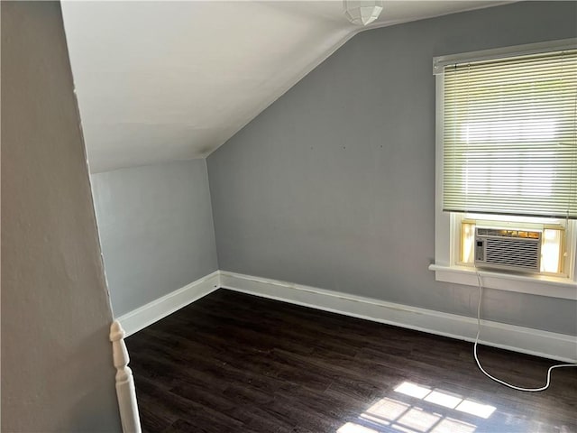 bonus room with lofted ceiling, dark wood-type flooring, cooling unit, and baseboards