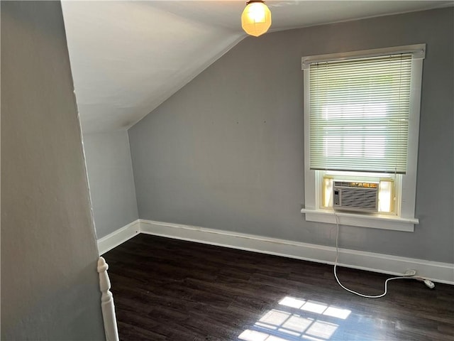 bonus room with lofted ceiling, dark wood-style flooring, cooling unit, and baseboards
