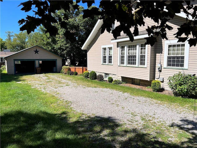 exterior space with an outbuilding, a garage, and a front lawn