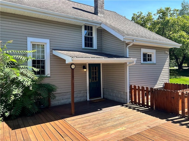 wooden terrace featuring fence