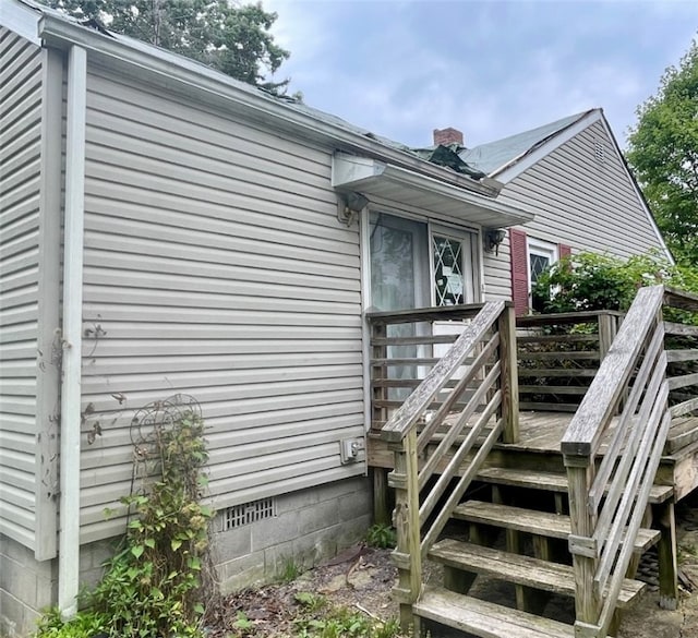 view of side of property featuring a wooden deck