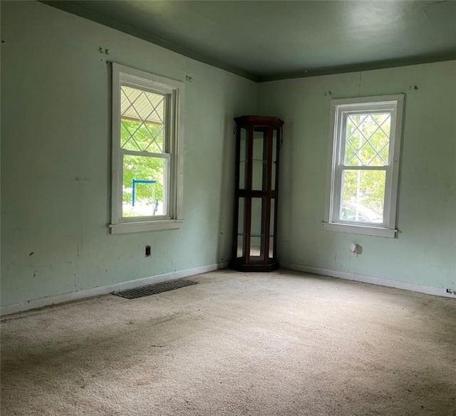 unfurnished room with light colored carpet