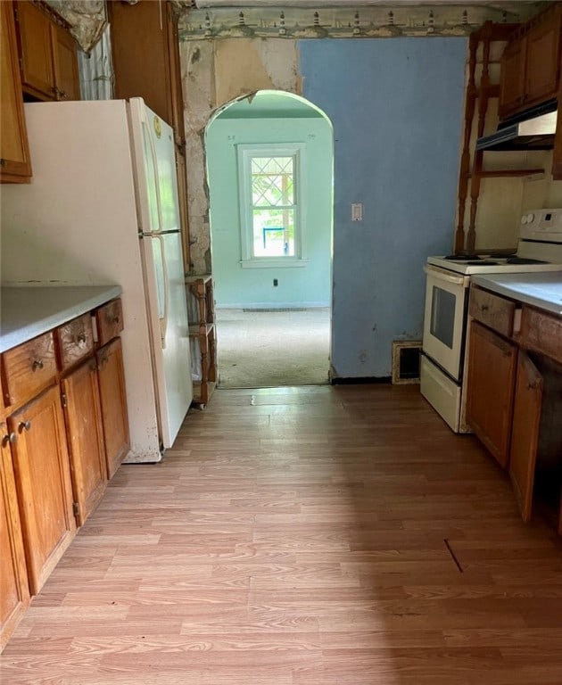 kitchen featuring white appliances and light hardwood / wood-style floors