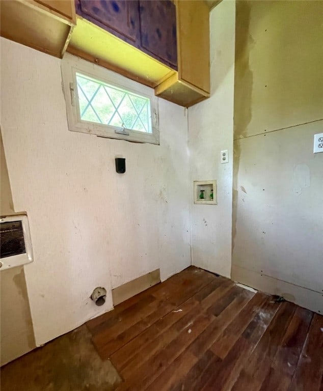 laundry room with hookup for a washing machine, hardwood / wood-style flooring, and cabinets