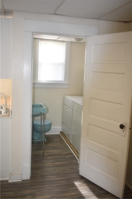 clothes washing area featuring dark hardwood / wood-style floors and separate washer and dryer