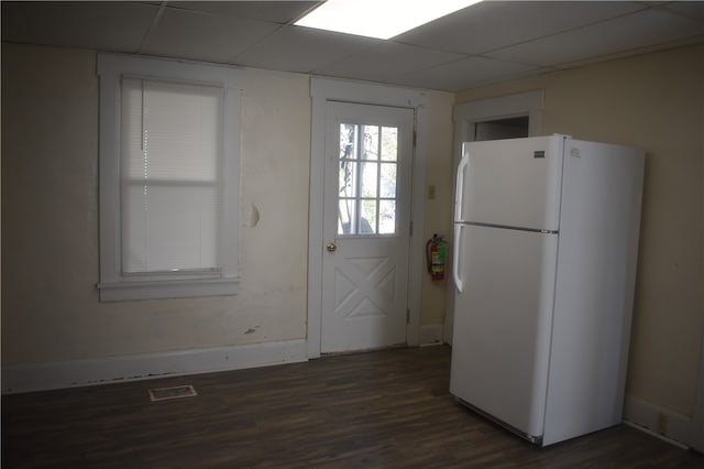 kitchen featuring dark hardwood / wood-style flooring, a paneled ceiling, and white fridge