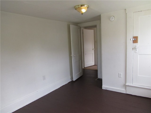 spare room featuring dark hardwood / wood-style floors