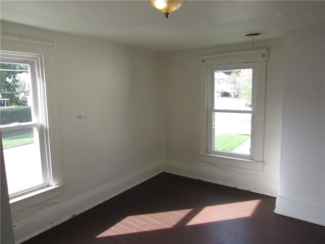 empty room with dark wood-type flooring