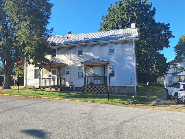 exterior space with a lawn and covered porch