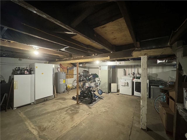 basement with water heater and washer and dryer