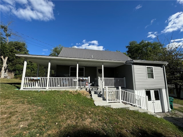 farmhouse with a porch and a front lawn