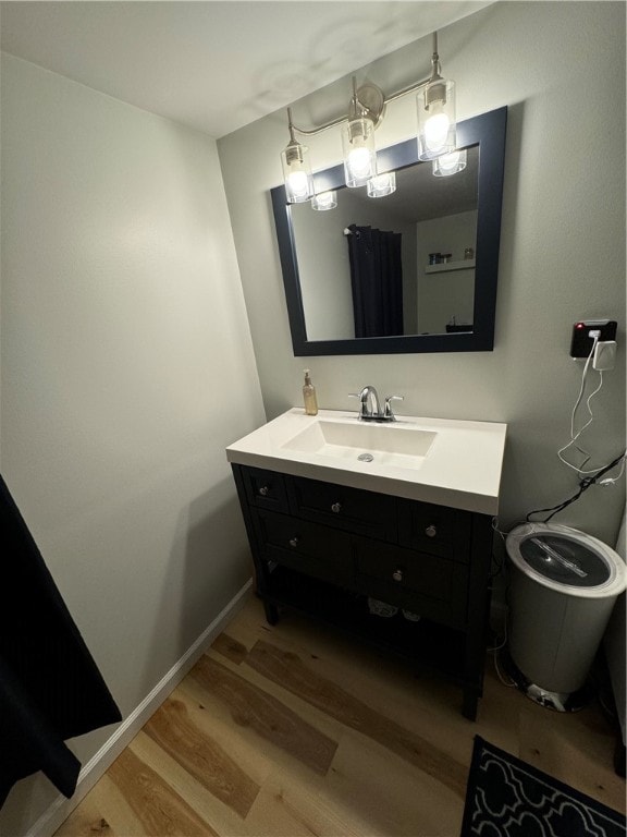 bathroom featuring vanity, toilet, and hardwood / wood-style floors