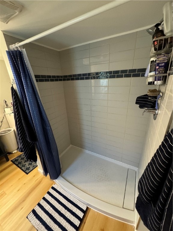 bathroom featuring wood-type flooring and walk in shower