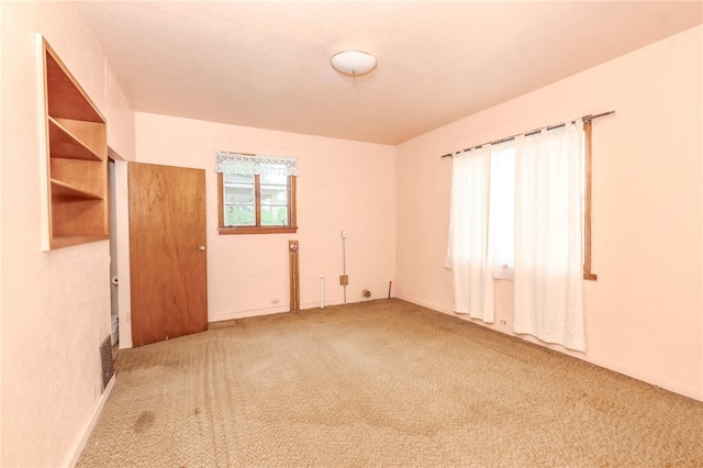 spare room featuring carpet