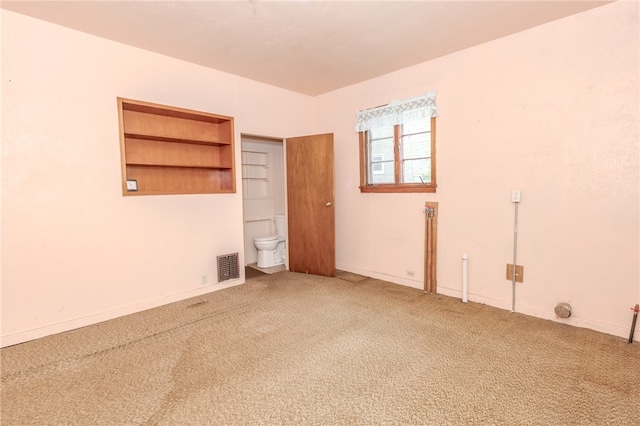 unfurnished room featuring carpet