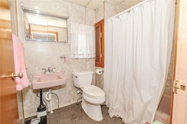 bathroom with shower / bath combination with curtain and toilet