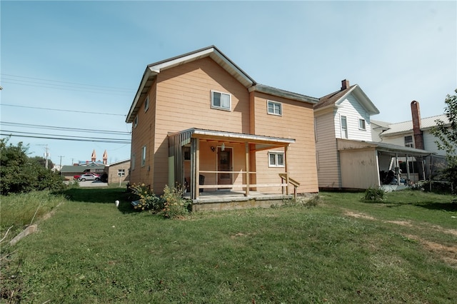 rear view of property with a yard