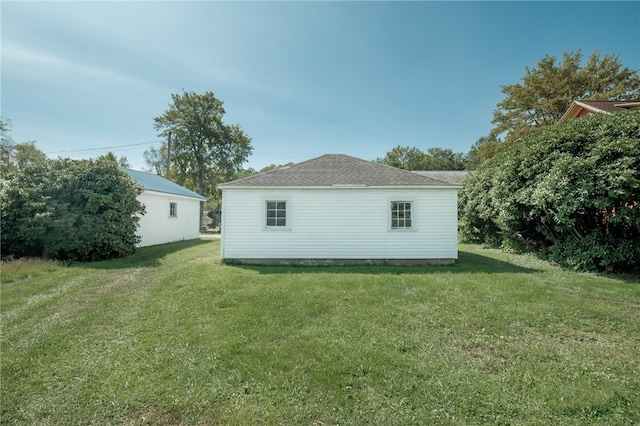 view of side of home with a yard