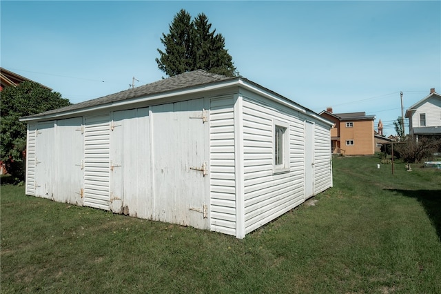 view of outbuilding with a yard