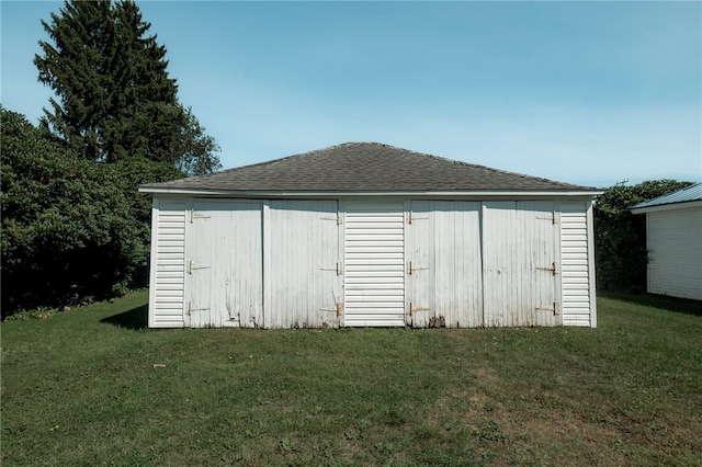 view of outbuilding featuring a lawn