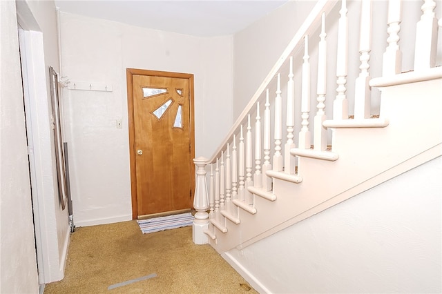 entryway with light colored carpet