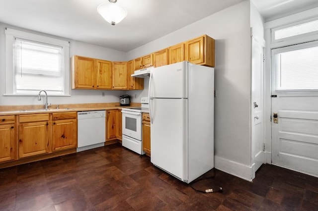 kitchen with sink, range hood, and white appliances