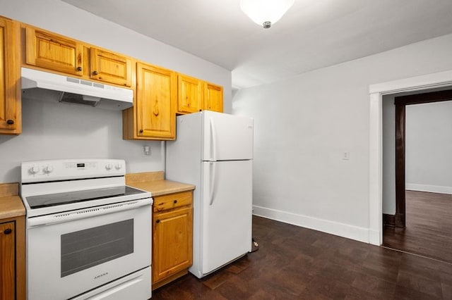 kitchen with dark wood-type flooring and white appliances