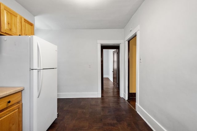 kitchen with white fridge and dark hardwood / wood-style flooring