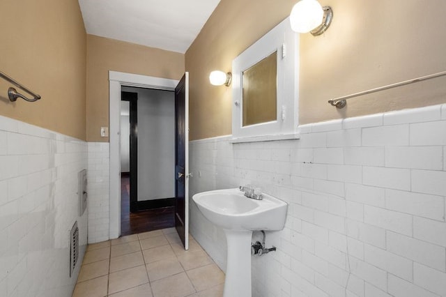 bathroom with tile walls and tile patterned floors