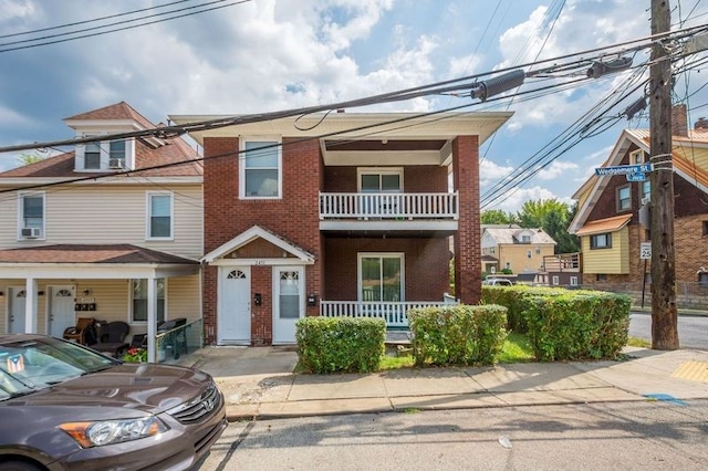 view of front of property featuring a balcony and a porch