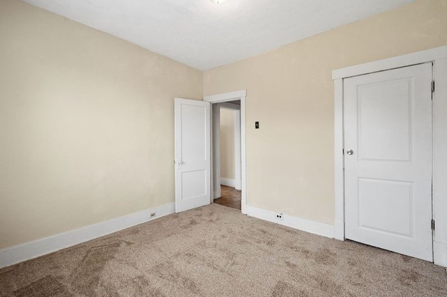 unfurnished bedroom featuring a closet and carpet flooring