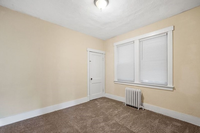 carpeted empty room with radiator