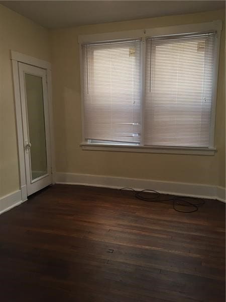 spare room featuring dark hardwood / wood-style flooring