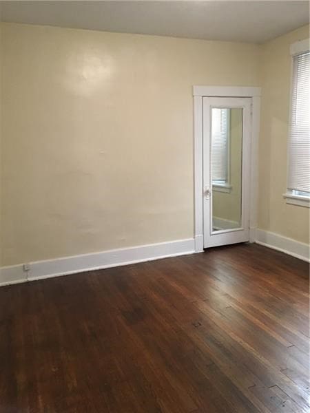 unfurnished room with dark hardwood / wood-style floors