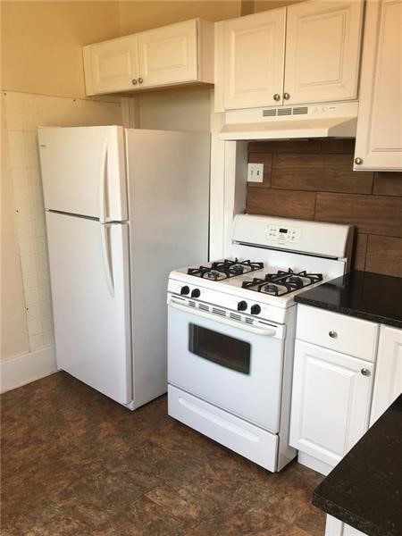 kitchen with white cabinetry and white appliances