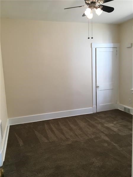 carpeted empty room with ceiling fan