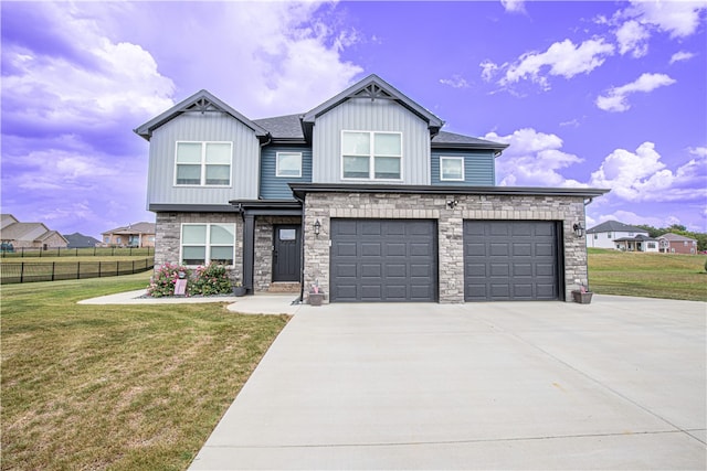 view of front of property with a garage and a front lawn