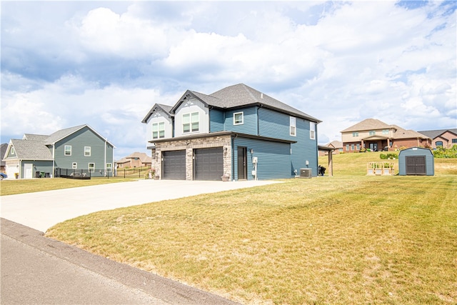 exterior space featuring a yard, a garage, a storage shed, and central AC unit