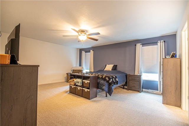 bedroom with ceiling fan and carpet