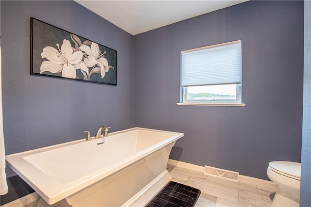 bathroom featuring toilet and a bathing tub