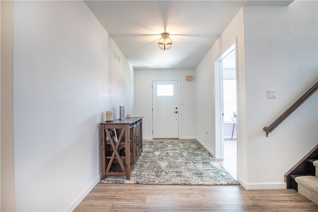 foyer entrance with hardwood / wood-style flooring