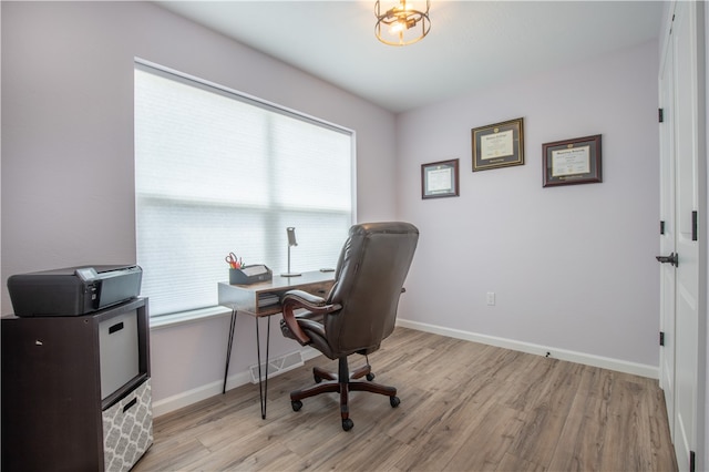 office area with light wood-type flooring and a wealth of natural light