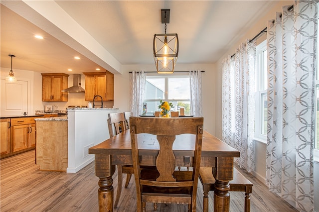 dining room featuring sink and light hardwood / wood-style flooring