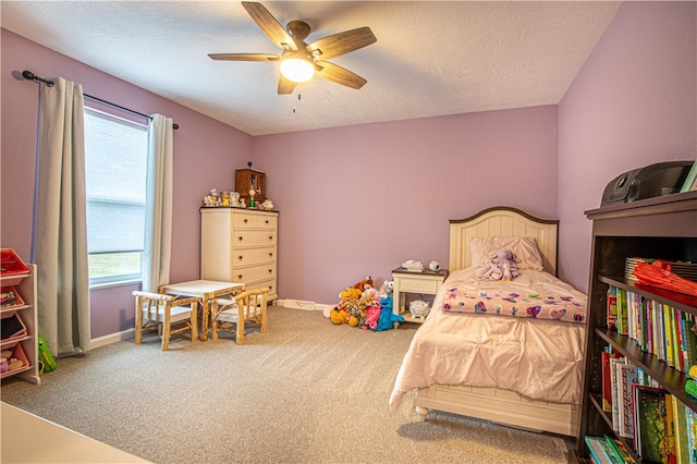 bedroom with a textured ceiling, ceiling fan, and carpet floors