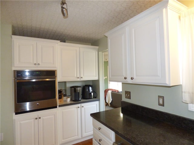 kitchen with oven and white cabinetry