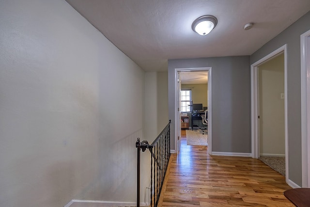 corridor with light wood-type flooring