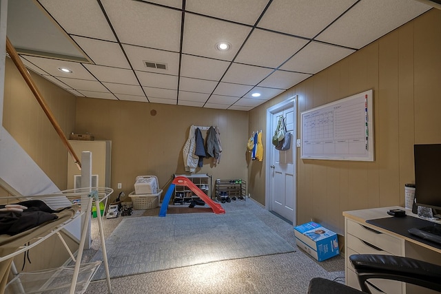 recreation room featuring carpet flooring and a drop ceiling