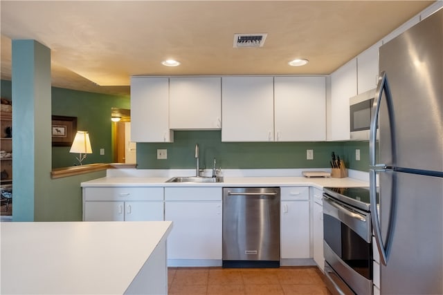 kitchen featuring white cabinets, appliances with stainless steel finishes, and sink