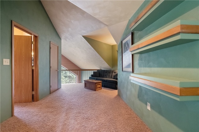 bonus room with lofted ceiling and carpet floors