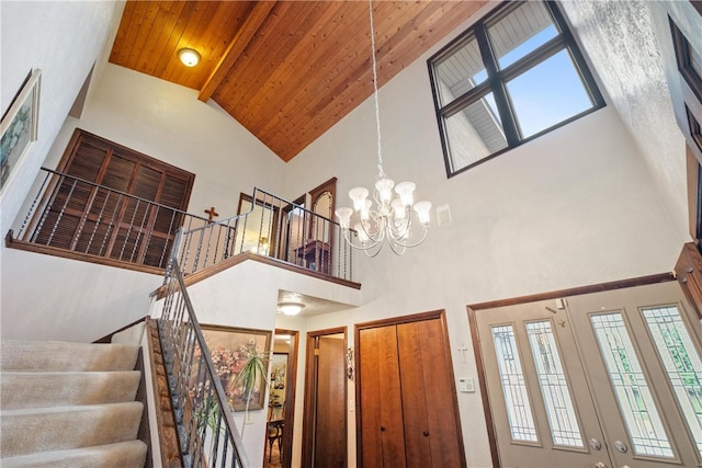 interior space with high vaulted ceiling, wood ceiling, and an inviting chandelier